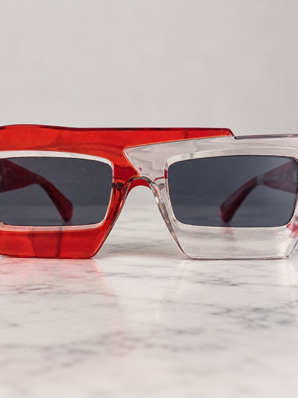 Bold Y2K-inspired statement sunglasses featuring a unique asymmetrical two-tone